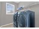 Laundry room with modern washer and dryer at 8106 Fan Palm Way, Kissimmee, FL 34747