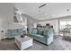 Open living room with light teal sofas and white coffee table at 8106 Fan Palm Way, Kissimmee, FL 34747