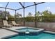 Relaxing pool and spa area with lounge chairs at 8106 Fan Palm Way, Kissimmee, FL 34747