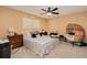 Cozy bedroom with a striped comforter and ceiling fan at 844 Sugar House Dr, Port Orange, FL 32129