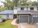 Two-story townhome with gray siding, gray garage door, and landscaped walkway at 844 Sugar House Dr, Port Orange, FL 32129