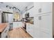 Modern kitchen with white cabinets, butcher block countertops, and stainless steel appliances at 844 Sugar House Dr, Port Orange, FL 32129