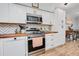 Modern kitchen with white cabinets, butcher block countertops, and stainless steel appliances at 844 Sugar House Dr, Port Orange, FL 32129