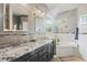Elegant bathroom with granite countertops and a soaking tub at 935 Don Wilson Ave, Apopka, FL 32712