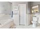 Elegant bathroom with granite countertops and a soaking tub at 935 Don Wilson Ave, Apopka, FL 32712