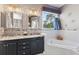Double vanity bathroom with granite countertop and corner tub at 935 Don Wilson Ave, Apopka, FL 32712