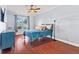 Bright bedroom featuring hardwood floors and a ceiling fan at 935 Don Wilson Ave, Apopka, FL 32712