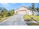 View of a house with a long concrete driveway leading up to a two-car garage, with manicured grass at 935 Don Wilson Ave, Apopka, FL 32712
