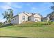 Charming single-Gathering home with neutral color, an attached two-car garage, and a well-manicured lawn at 935 Don Wilson Ave, Apopka, FL 32712