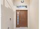 Brown front door with sidelights and transom at 935 Don Wilson Ave, Apopka, FL 32712