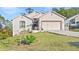 Charming single Gathering home with a 2-car garage, mature trees, and a lush lawn at 935 Don Wilson Ave, Apopka, FL 32712