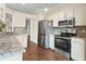 Modern kitchen with stainless steel appliances and granite countertops at 935 Don Wilson Ave, Apopka, FL 32712