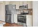 Modern kitchen with granite countertops and stainless steel appliances at 935 Don Wilson Ave, Apopka, FL 32712