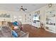Spacious living room with hardwood floors, built-in shelving, and a large TV at 935 Don Wilson Ave, Apopka, FL 32712
