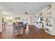 Spacious living room with hardwood floors, built-in shelving, and a large TV at 935 Don Wilson Ave, Apopka, FL 32712