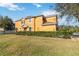 Two-story house with orange exterior and landscaped yard at 9496 Strongbark Ln, Orlando, FL 32832