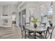 Casual breakfast nook with a round table and four chairs, adjacent to a sunlit window at 11013 Creighton Dr, Orlando, FL 32817