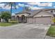 Two-story house with a large driveway and landscaped front yard at 11013 Creighton Dr, Orlando, FL 32817