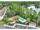 Aerial view of community pool, clubhouse, and lake at 1102 Victoria Glen Dr, Sanford, FL 32773