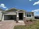 One-story home with attached garage and landscaped yard at 1141 Lakeshore Breeze Pl, Kissimmee, FL 34747