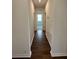 Hallway with wood-look floors and doors to bedrooms at 1141 Lakeshore Breeze Pl, Kissimmee, FL 34747