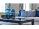 Close up of a coffee table with blue glass vases and pillows at 1218 Limbali St, Mount Dora, FL 32757