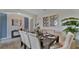 Elegant dining room with a dark wood table and neutral chairs at 1218 Limbali St, Mount Dora, FL 32757