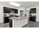 Modern kitchen with dark cabinetry and granite counters at 14031 Willow Grace, Orlando, FL 32824