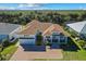 Aerial view of a house and neighborhood, showcasing the property's location and surroundings at 1406 Saxon Dr, New Smyrna Beach, FL 32169