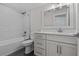 Modern bathroom with white cabinets and a tiled shower/tub combo at 1406 Saxon Dr, New Smyrna Beach, FL 32169