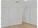 Well-lit bedroom featuring hardwood floors and double door closet at 1406 Saxon Dr, New Smyrna Beach, FL 32169