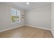 Bright bedroom with wood floors and window shutters at 1406 Saxon Dr, New Smyrna Beach, FL 32169