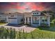 White two-story house with a brown roof, front porch, and a landscaped yard at 1406 Saxon Dr, New Smyrna Beach, FL 32169