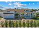 White two-story house with a brown roof, front porch, and landscaping at 1406 Saxon Dr, New Smyrna Beach, FL 32169