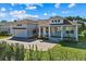 Two-story house with a white exterior, attached garage, and nicely landscaped yard at 1406 Saxon Dr, New Smyrna Beach, FL 32169