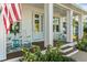 Inviting front porch with rocking chairs, a teal side table, and a welcoming atmosphere at 1406 Saxon Dr, New Smyrna Beach, FL 32169