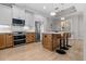 Modern kitchen with wood and white cabinets, stainless steel appliances, and an island with seating at 1406 Saxon Dr, New Smyrna Beach, FL 32169