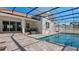 Enclosed pool and patio with pavers, and a covered patio at 1406 Saxon Dr, New Smyrna Beach, FL 32169