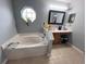 Main bathroom features a corner tub and double vanity at 15824 Marsh Elder St, Clermont, FL 34711