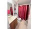 Clean bathroom with a shower/tub combo and wood vanity at 15824 Marsh Elder St, Clermont, FL 34711