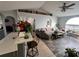 Living room with gray sectional sofa and tile floors at 15824 Marsh Elder St, Clermont, FL 34711