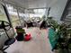 Relaxing screened porch with wicker furniture and potted plants at 15824 Marsh Elder St, Clermont, FL 34711