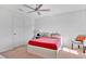 Bedroom with red bedding and gray accent chair at 1643 Wynford Cir, Tavares, FL 32778