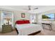 Bright bedroom featuring a king-size bed and a large TV at 1643 Wynford Cir, Tavares, FL 32778