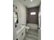 Modern bathroom with gray tile, white vanity, and bathtub at 16674 Sw 25Th Ct, Ocala, FL 34473