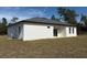 Back of house with white exterior and gray roof at 16674 Sw 25Th Ct, Ocala, FL 34473