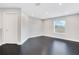 Empty bedroom with dark hardwood floors and a window at 1763 Stargazer Ter, Sanford, FL 32771