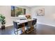 Modern dining room with dark wood floors and a large window at 1763 Stargazer Ter, Sanford, FL 32771