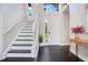 Bright entryway with staircase, dark hardwood floors, and a view to the backyard at 1763 Stargazer Ter, Sanford, FL 32771