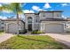 Two story house with gray siding, three car garage, and landscaping at 1763 Stargazer Ter, Sanford, FL 32771